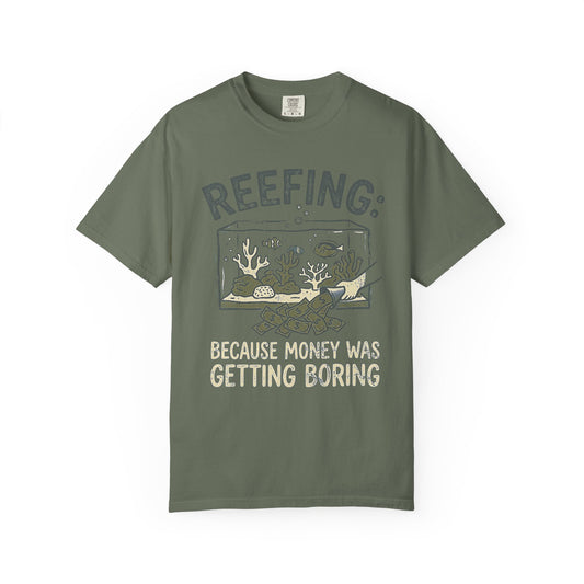 Broke Reefers graphic t-shirt featuring a hand pouring money into a reef aquarium with the text REEFING: BECAUSE MONEY WAS GETTING BORING, [Color] crew neck tee