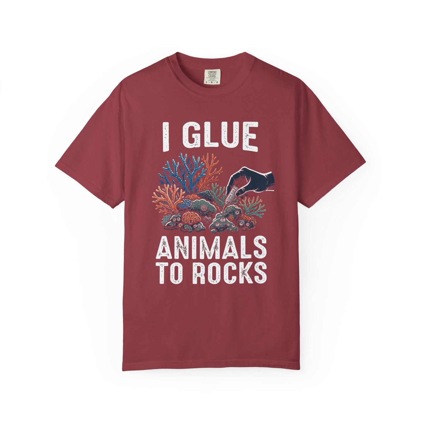 Broke Reefers saltwater aquarium graphic t-shirt featuring a high-contrast illustration of a gloved hand applying super glue to coral, with bold text: I GLUE ANIMALS TO ROCKS, maroon crew neck tee
