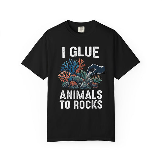 Broke Reefers saltwater aquarium graphic t-shirt featuring a high-contrast illustration of a gloved hand applying super glue to coral, with bold text: I GLUE ANIMALS TO ROCKS, black crew neck tee