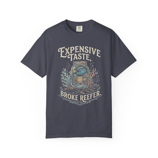 Broke Reefers saltwater aquarium graphic t-shirt featuring a detailed illustration of a fish in a jar with the text: EXPENSIVE TASTE, BROKE REEFER. EST. 1996, navy crew neck tee