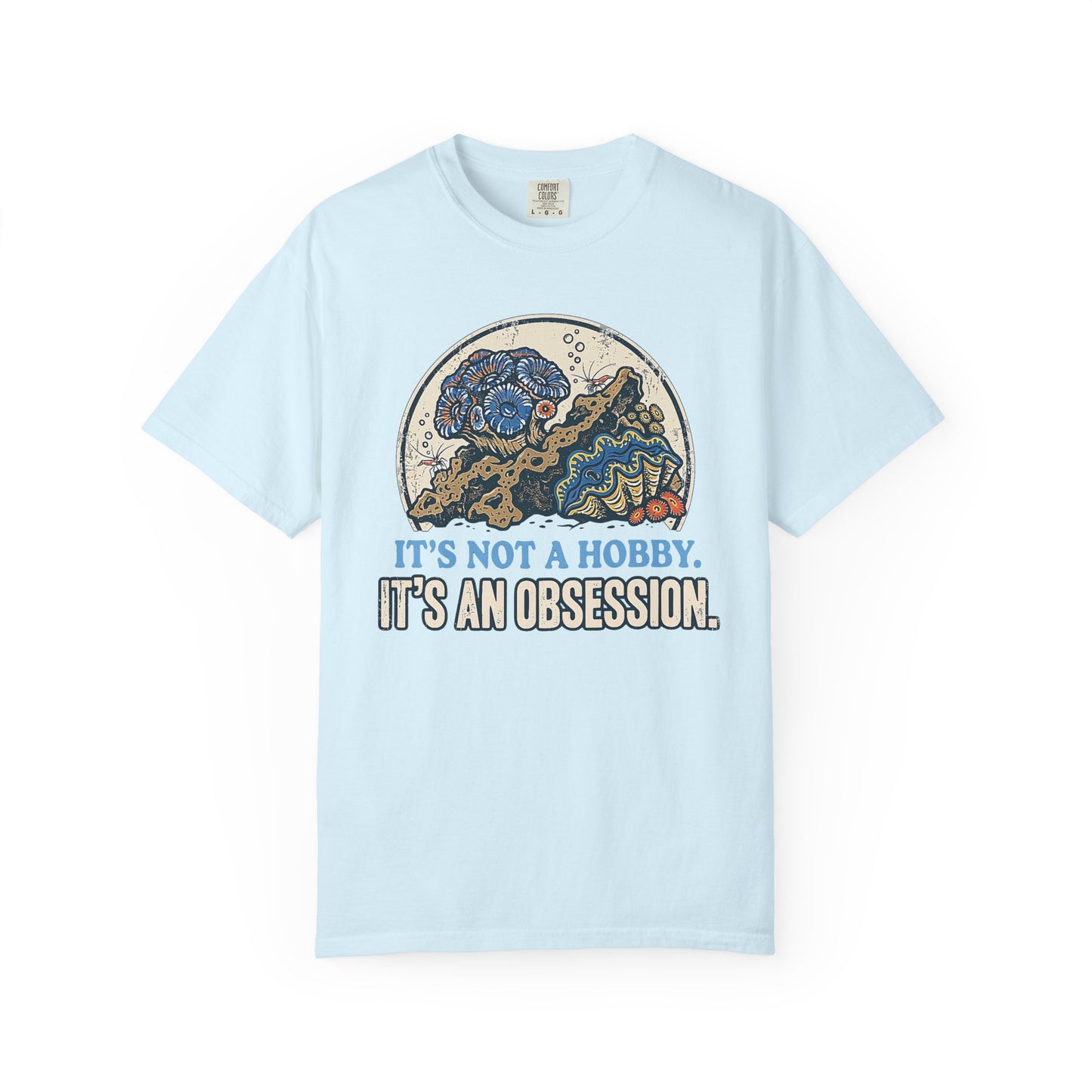 Broke Reefers saltwater aquarium graphic t-shirt featuring a detailed, vintage-style circular illustration of a thriving reef scene with the text: IT'S NOT A HOBBY. IT'S AN OBSESSION., light blue crew neck tee