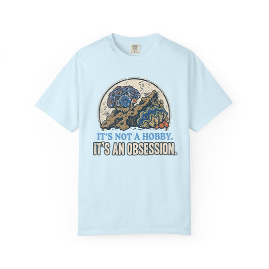 Broke Reefers saltwater aquarium graphic t-shirt featuring a detailed, vintage-style circular illustration of a thriving reef scene with the text: IT'S NOT A HOBBY. IT'S AN OBSESSION., light blue crew neck tee