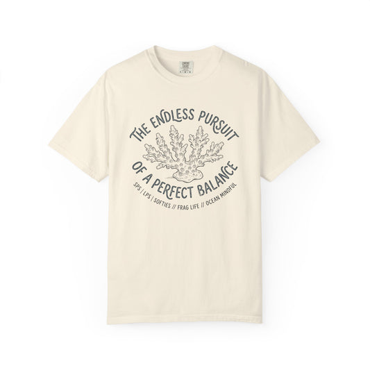 Broke Reefers saltwater aquarium graphic t-shirt featuring an etched-style coral illustration with text: THE ENDLESS PURSUIT OF A PERFECT BALANCE, SPS | LPS | SOFTIES // FRAG LIFE // OCEAN MINDFUL, beige cream crew neck tee