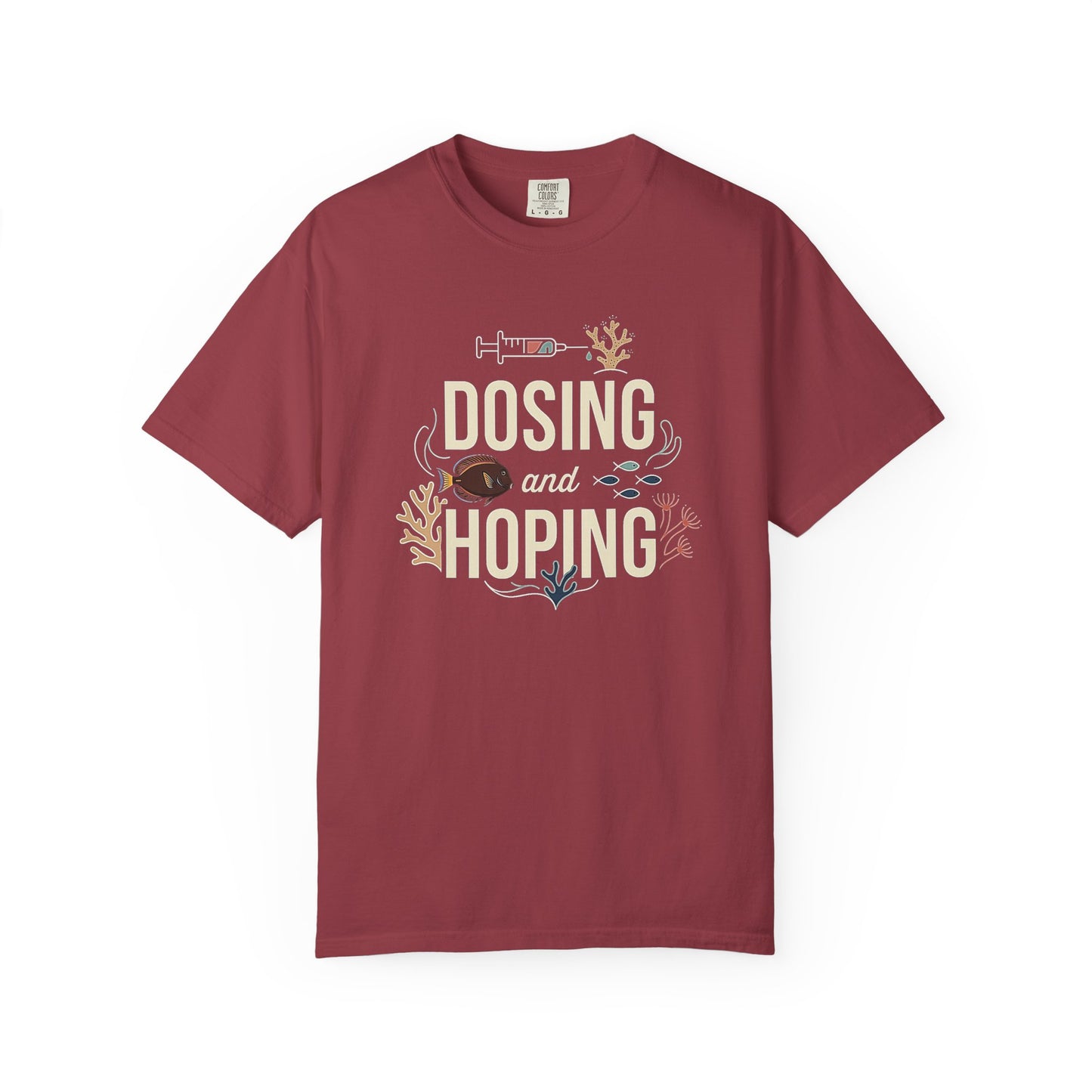 Broke Reefers graphic t-shirt featuring an illustration of a syringe and reef life with the text: DOSING AND HOPING, maroon crew neck tee
