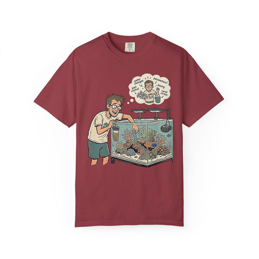 Broke Reefers saltwater aquarium graphic t-shirt featuring a detailed illustration of a reef-keeper tending to their tank with a thought bubble of reefing chores, maroon crew neck tee
