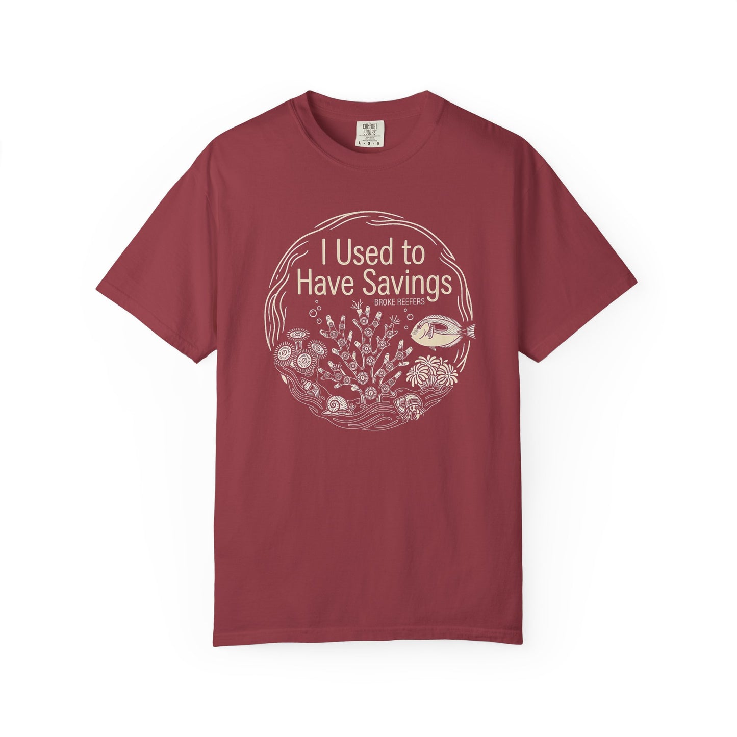 Broke Reefers graphic t-shirt featuring a circular line-art illustration of reef life and the text: I USED TO HAVE SAVINGS, maroon crew neck tee