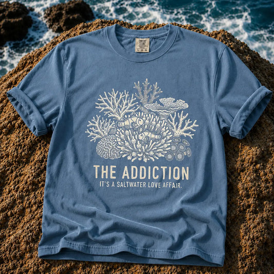 Broke Reefers saltwater aquarium graphic t-shirt featuring an intricate engraving-style illustration of clownfish in an anemone with the text: THE ADDICTION, IT'S A SALTWATER LOVE AFFAIR., blue crew neck tee